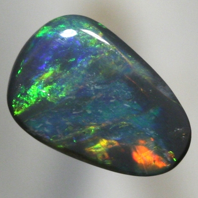 SOLID BLACK OPAL Orange to green with a hue of blue. SEE VIDEO